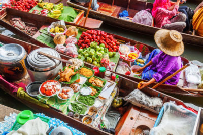 Bangkok, Thailand - December 13, 2014: unidentified market woman on the famous floating market Damnoen Saduak in Bangkok. It is a traditional market on the khlongs, where they sell goods and food from the boats.